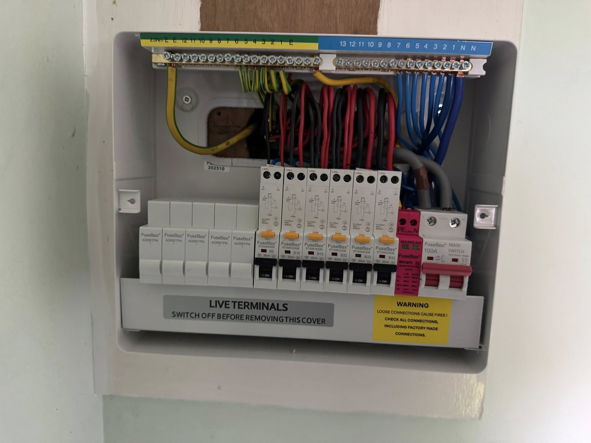 Open consumer unit with circuit breakers and wiring