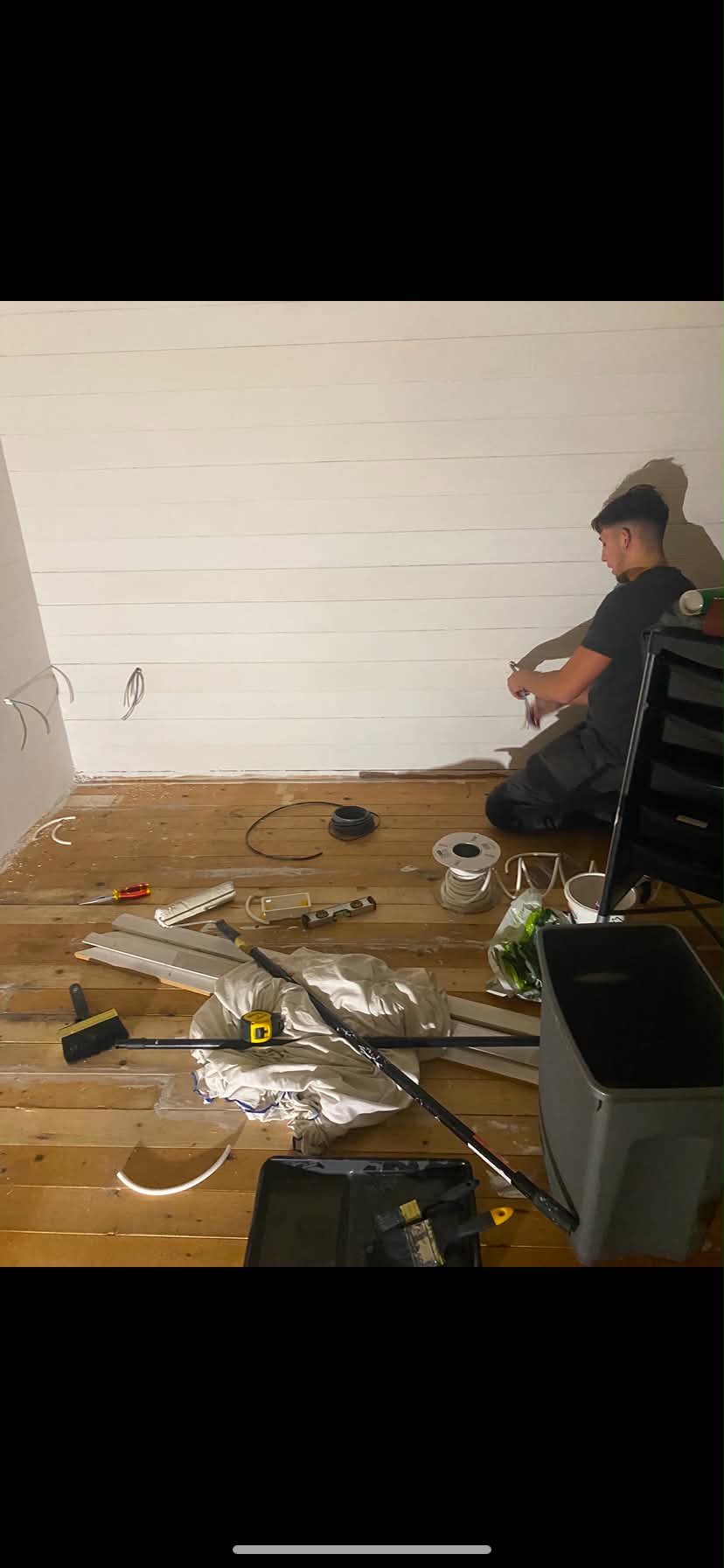 Electrician installing wiring in garage space