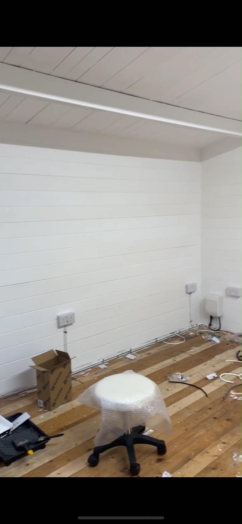 Interior room under construction with white shiplap walls